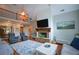 Open living room with a stone fireplace, vaulted ceiling, and views of the upstairs loft at 700 Broadlands Ln, Powder Springs, GA 30127