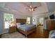 Spacious bedroom features a tray ceiling, hardwood floors, and a lovely ensuite bathroom at 700 Broadlands Ln, Powder Springs, GA 30127