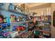 Walk-in pantry with metal shelving filled with a variety of food items and household goods for convenient storage at 700 Broadlands Ln, Powder Springs, GA 30127