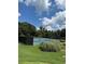 Community tennis courts with black fencing and lush green lawns at 700 Broadlands Ln, Powder Springs, GA 30127