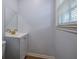 A bathroom with a modern vanity, gold faucet, and a large mirror at 7144 Carolyn Cir, Lithia Springs, GA 30122