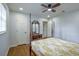 This bedroom offers natural light, hardwood floors, and an en-suite bathroom at 7144 Carolyn Cir, Lithia Springs, GA 30122
