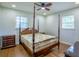 A bright bedroom features hardwood floors, a ceiling fan, and large windows at 7144 Carolyn Cir, Lithia Springs, GA 30122
