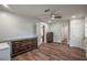 Bedroom with wood floors, ceiling fan, neutral paint, and multiple closets and doors at 7144 Carolyn Cir, Lithia Springs, GA 30122