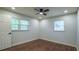 This bright bedroom offers two windows, hardwood floors, and neutral paint at 7144 Carolyn Cir, Lithia Springs, GA 30122