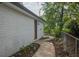 A winding walkway to a house with a white brick exterior and a garden on the side at 7144 Carolyn Cir, Lithia Springs, GA 30122