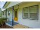 A welcoming front porch with classic columns, and a bright door, leading to the home's entrance at 7144 Carolyn Cir, Lithia Springs, GA 30122