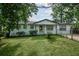 Classic home featuring a lush lawn and mature trees providing shade and scenic beauty at 7144 Carolyn Cir, Lithia Springs, GA 30122