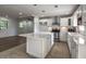 Bright kitchen with white cabinets, stainless steel appliances, island, and open to the living room at 7144 Carolyn Cir, Lithia Springs, GA 30122