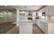 Bright kitchen boasts white cabinets, stainless steel appliances, and a large center island at 7144 Carolyn Cir, Lithia Springs, GA 30122