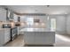 Kitchen with white cabinets, subway tile backsplash, stainless steel appliances, and large island at 7144 Carolyn Cir, Lithia Springs, GA 30122