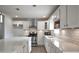Modern kitchen with white cabinets, stainless steel appliances and quartz countertops at 7144 Carolyn Cir, Lithia Springs, GA 30122