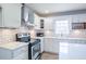 Close up of updated kitchen with subway tile, stainless steel appliances, and modern fixtures at 7144 Carolyn Cir, Lithia Springs, GA 30122