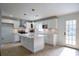 Modern kitchen with white cabinets, stainless steel appliances, an island and stylish backsplash at 7144 Carolyn Cir, Lithia Springs, GA 30122