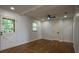 Well-lit living room offering great space with hardwood floors, and a ceiling fan at 7144 Carolyn Cir, Lithia Springs, GA 30122