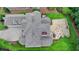 Birds eye view of a home with a stone patio and three-car garage at 8230 Royal Melbourne Way, Duluth, GA 30097