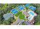 Aerial view of the property with tennis courts, pickleball, pool and clubhouse, showing a great recreational space at 8230 Royal Melbourne Way, Duluth, GA 30097