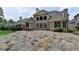 Spacious backyard with a stone patio, lush lawn, and a well-manicured garden, great for outdoor entertaining at 8230 Royal Melbourne Way, Duluth, GA 30097