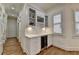 Bar features white cabinets, marble counters, a wine rack, and a beverage cooler at 8230 Royal Melbourne Way, Duluth, GA 30097