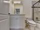 Bathroom featuring a vanity with marble countertops, toilet, and shower with glass door at 8230 Royal Melbourne Way, Duluth, GA 30097