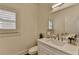 Powder room featuring marble countertop, faucet and white cabinets at 8230 Royal Melbourne Way, Duluth, GA 30097