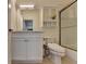 Bathroom with a vanity, toilet, mirror, shower with sliding glass door and tile flooring at 8230 Royal Melbourne Way, Duluth, GA 30097