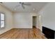 Bedroom featuring hardwood floors, crown molding, and ceiling fan at 8230 Royal Melbourne Way, Duluth, GA 30097