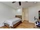 Bedroom with a desk, ceiling fan, hardwood floors, and a bed at 8230 Royal Melbourne Way, Duluth, GA 30097