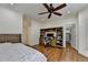 Bedroom featuring hardwood floors, built-in desk, ceiling fan and an open doorway to a walk-in closet at 8230 Royal Melbourne Way, Duluth, GA 30097
