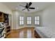 Bedroom with a bay window, ceiling fan, wood floors and a work desk at 8230 Royal Melbourne Way, Duluth, GA 30097