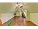 Bonus room with hardwood floors, a ceiling fan, and golf putting area at 8230 Royal Melbourne Way, Duluth, GA 30097