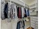 Spacious walk-in closet with lots of clothing, shelves and a built-in dresser at 8230 Royal Melbourne Way, Duluth, GA 30097