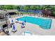 Large community pool surrounded by lounge chairs and a clubhouse at 8230 Royal Melbourne Way, Duluth, GA 30097