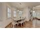 Dining room features hardwood floors, natural light, and an open floor plan at 8230 Royal Melbourne Way, Duluth, GA 30097