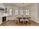 Dining room features hardwood floors, a wine cooler, and natural light at 8230 Royal Melbourne Way, Duluth, GA 30097