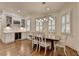Elegant dining room features hardwood floors, white trim, and abundant natural light from shuttered windows at 8230 Royal Melbourne Way, Duluth, GA 30097