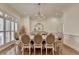 Elegant dining room with a chandelier, large table, and window shutters at 8230 Royal Melbourne Way, Duluth, GA 30097