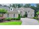 Stunning brick home with manicured landscaping and a beautiful stone driveway at 8230 Royal Melbourne Way, Duluth, GA 30097