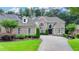 Stunning brick home with manicured landscaping and a beautiful stone driveway at 8230 Royal Melbourne Way, Duluth, GA 30097