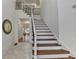 Elegant foyer with hardwood stairs, iron railings, and tiled flooring at 8230 Royal Melbourne Way, Duluth, GA 30097