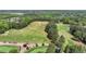 Scenic aerial view of a lush golf course with meticulously maintained fairways and greens, a golfer's paradise at 8230 Royal Melbourne Way, Duluth, GA 30097
