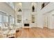 Light-filled living room with hardwood floors, fireplace, and elegant built-in shelves at 8230 Royal Melbourne Way, Duluth, GA 30097
