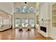 Bright living room boasts large windows, a fireplace, and hardwood floors at 8230 Royal Melbourne Way, Duluth, GA 30097
