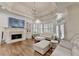 Bright living room with fireplace, coffered ceiling, and access to the outdoors at 8230 Royal Melbourne Way, Duluth, GA 30097