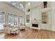 Bright living room features a fireplace, hardwood floors, and built-in shelving at 8230 Royal Melbourne Way, Duluth, GA 30097