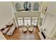 Bright living room with tall windows, hardwood floors, a fireplace and a ceiling fan at 8230 Royal Melbourne Way, Duluth, GA 30097