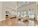 Open living room with hardwood floors, fireplace, and lots of natural light at 8230 Royal Melbourne Way, Duluth, GA 30097