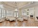 Spacious living room with fireplace, hardwood floors, and view into kitchen at 8230 Royal Melbourne Way, Duluth, GA 30097
