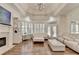 Living room with fireplace, coffered ceiling, and doors to the back at 8230 Royal Melbourne Way, Duluth, GA 30097