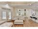 Open-concept living room with hardwood floors, fireplace, and kitchen view at 8230 Royal Melbourne Way, Duluth, GA 30097